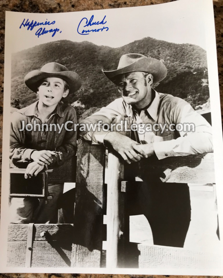 a photograph of Johnny Crawford and Chuck Connors with an autograph