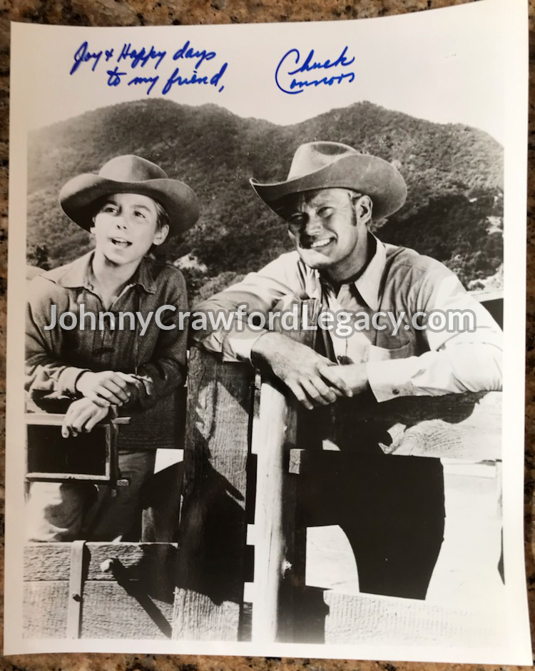 a photograph of Johnny Crawford and Chuck Connors with an autograph