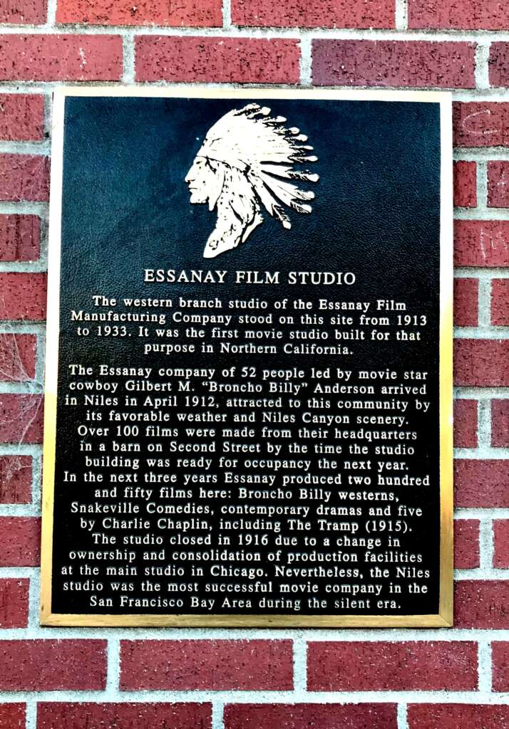 An image of a black commemorative plaque describing the silent film studio.